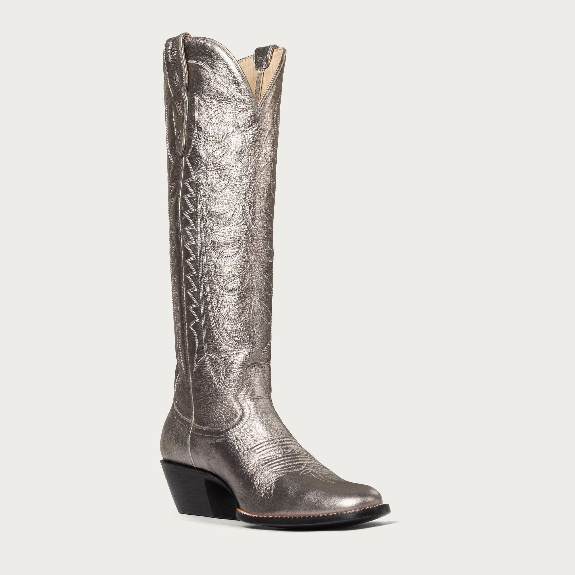 Silver metallic cowboy boot on a white background