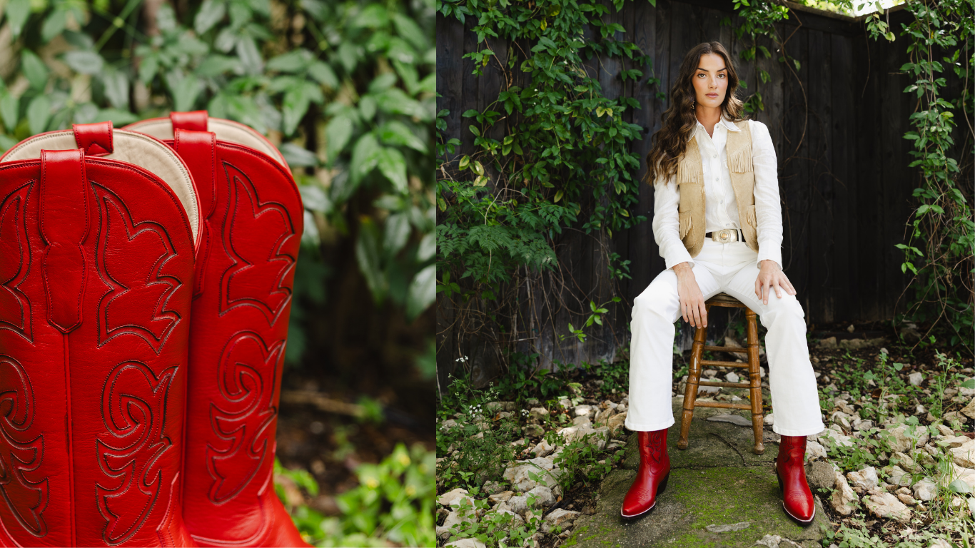 Person wearing red boots and white outfit sitting outdoors with a large red boot in the foreground.