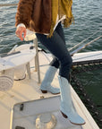 Wearing CITY Boots Inwood powder blue cowboy boots on a boat